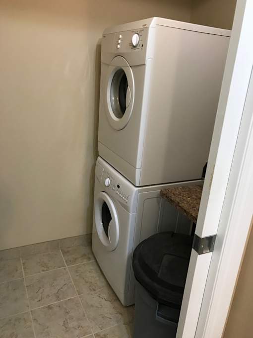 a washing machine and dryer in a bathroom