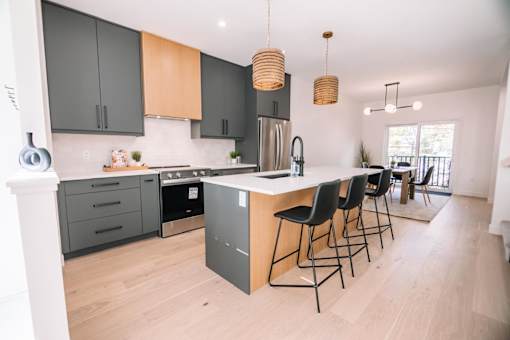 A modern kitchen with a large island and bar stools.
