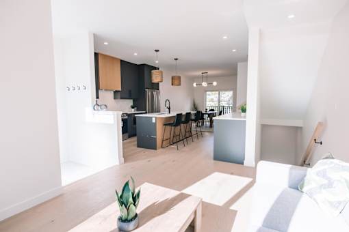 A modern kitchen with a dining area and a living room.
