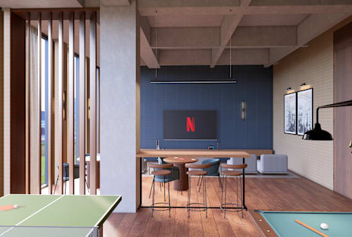 A room with a pool table and a TV displaying the Netflix logo.