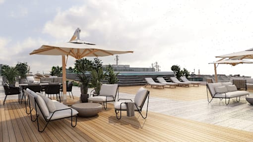 A patio with chairs and tables is set up on a wooden deck.
