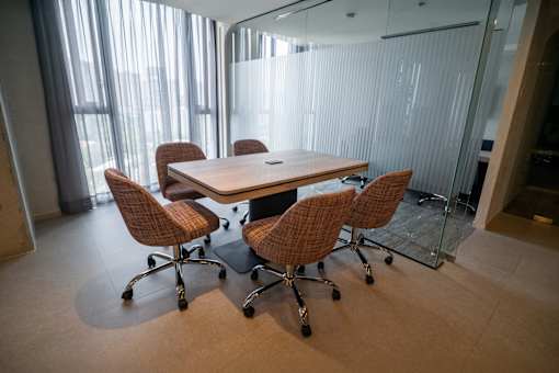 A conference room with a table and chairs.