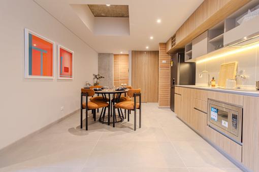 A modern kitchen with a dining table and chairs.
