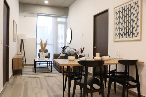 a dining room with a table and chairs and a living room with