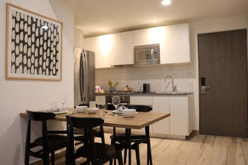 a kitchen and dining area with a wooden table and chairs