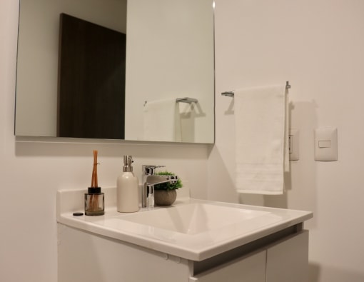 a small bathroom with a sink and a mirror
