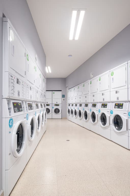 a row of washing machines in a laundromat