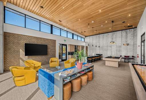 A room with a pool table and a bar area.
