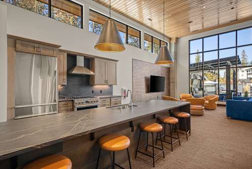 A modern kitchen with a long island and bar stools.