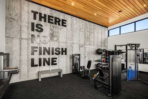 A gym with a wall that says "There is no finish line".
