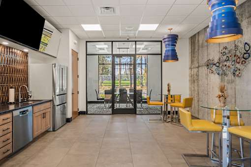 A modern kitchen with a dining area and a television.