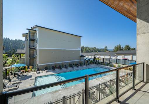 A large building with a pool in front of it.