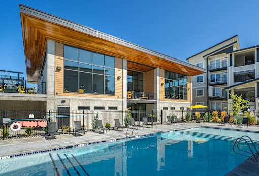 A modern building with a pool in front.