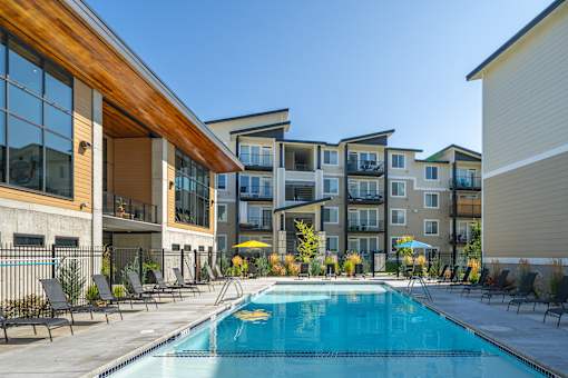 A swimming pool in front of apartment buildings.