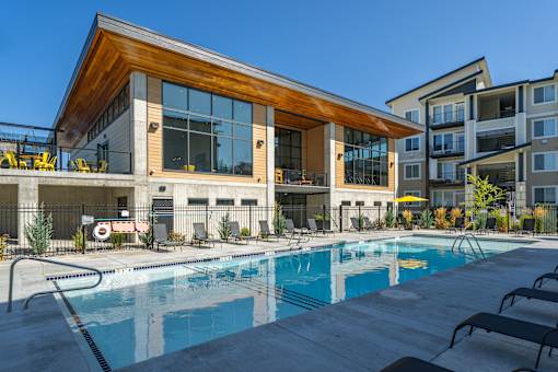 A modern building with a pool in front.