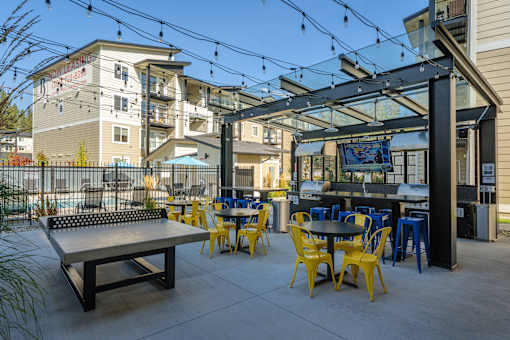 A patio with tables and chairs is set up outside a building.