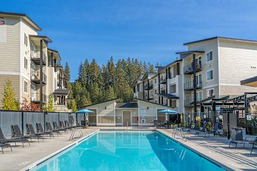A swimming pool in front of apartment buildings.