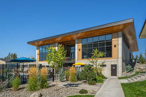 A modern building with a wooden facade and glass windows.