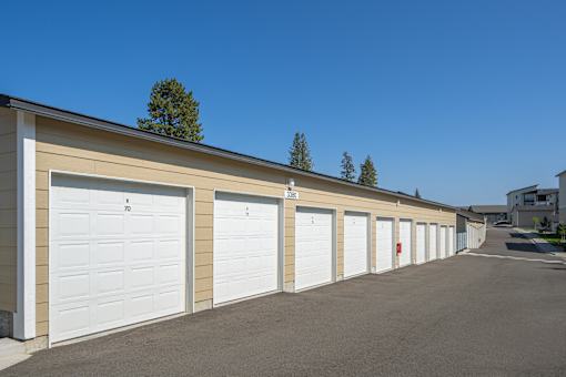 A row of garage doors are closed and numbered from 1 to 7.