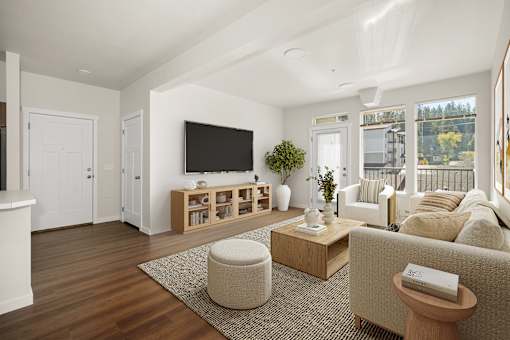 A living room with a flat screen TV and a large window.