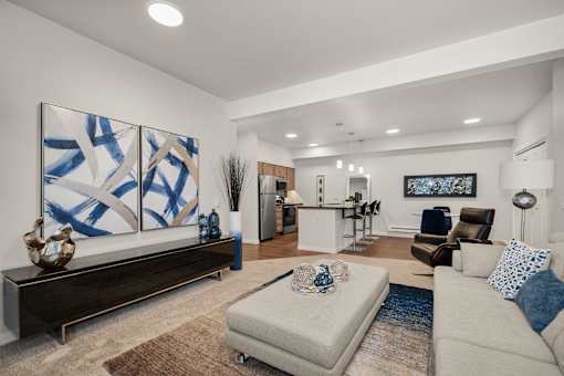 A modern living room with a large abstract painting on the wall.
