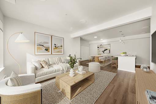 A modern living room with a white sofa, a wooden coffee table, and a large painting on the wall.