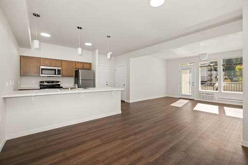 A kitchen with white cabinets and a wooden countertop.