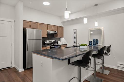 A modern kitchen with a large island and stainless steel appliances.