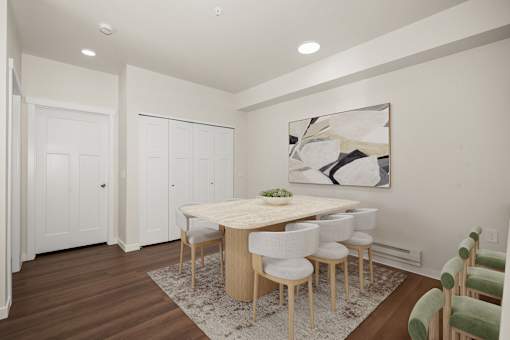 A dining room with a table and chairs.