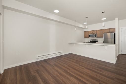 A kitchen with a wooden floor and white walls.
