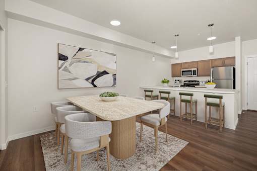 A modern kitchen with a dining table and chairs.