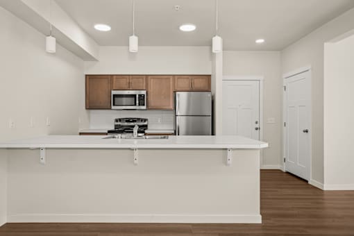 A kitchen with a white countertop and brown cabinets.