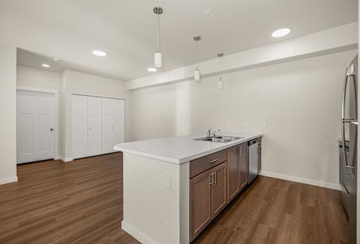 A kitchen with white cabinets and a wooden island.