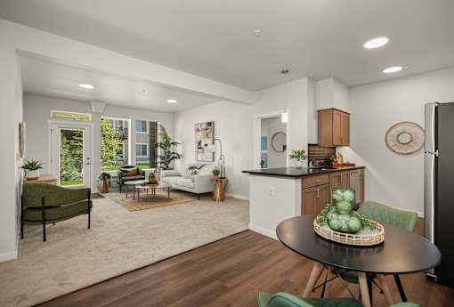 A modern kitchen and living room with a dining table and chairs.