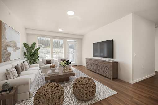 A modern living room with a white couch, a wooden coffee table, and a flat-screen TV.