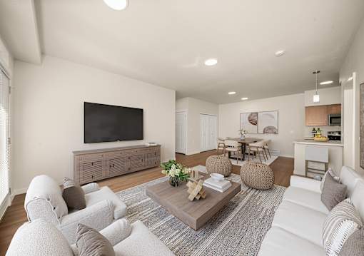 A living room with a white couch and a wooden coffee table.
