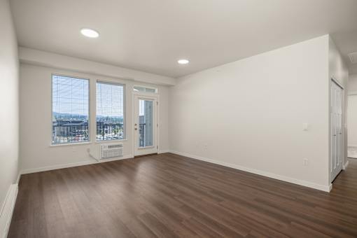 A room with a brown floor and white walls.
