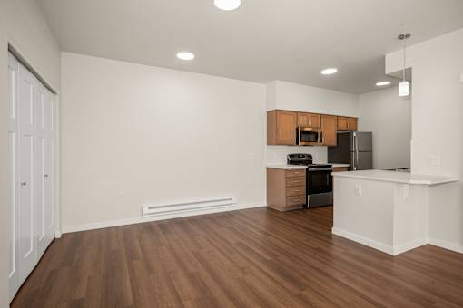 A kitchen with wooden floors and white walls.