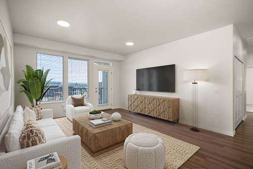 A modern living room with a flat screen TV and a large window.