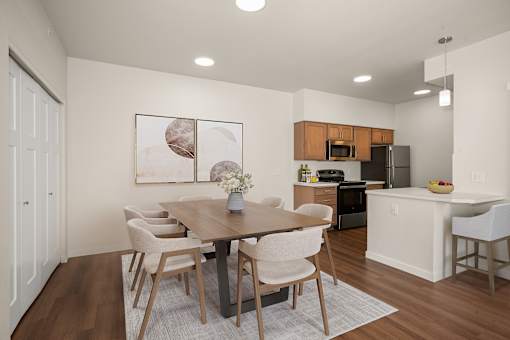 A modern dining room with a wooden table and chairs.