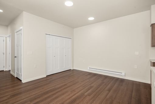 A room with wooden floors and white walls.