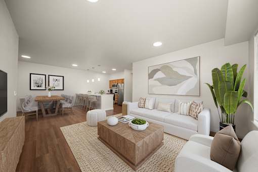 A living room with a white couch, a coffee table, and a dining table with chairs.