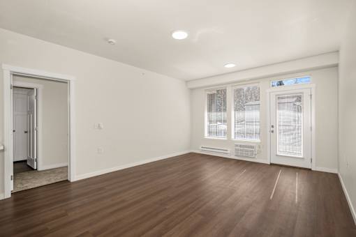A room with wooden floors and white walls.