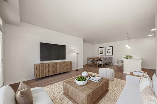 A modern living room with a flat screen TV, a coffee table, and a sofa.