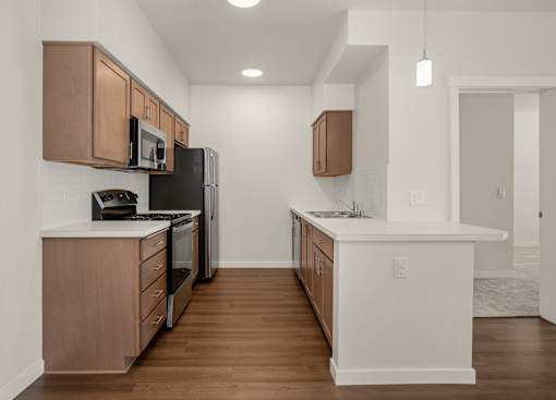 A kitchen with wooden cabinets and black appliances.