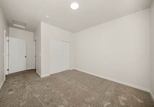 A room with carpeted floor and white walls.