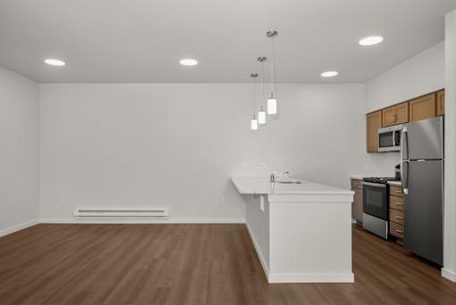 A kitchen with a white island and stainless steel appliances.