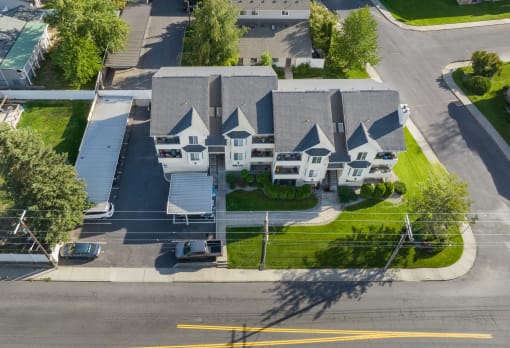 an aerial view of a neighborhood of houses on a street