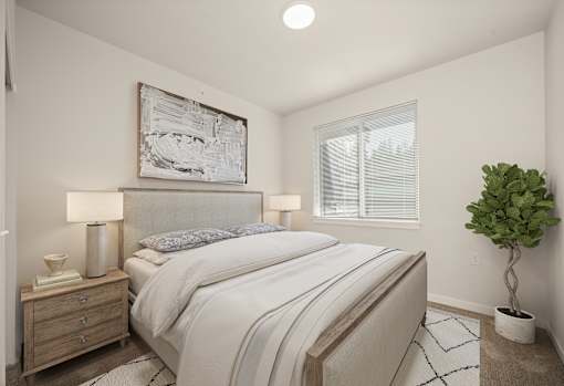 A bedroom with a large bed, a nightstand with a lamp, a plant, and a framed picture on the wall.