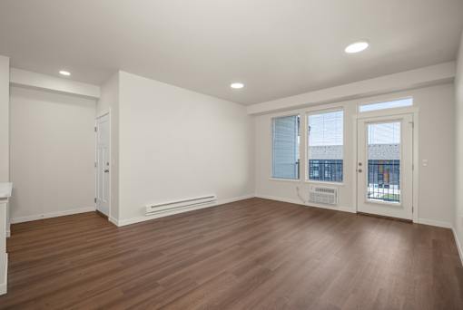 A room with wooden floors and white walls.